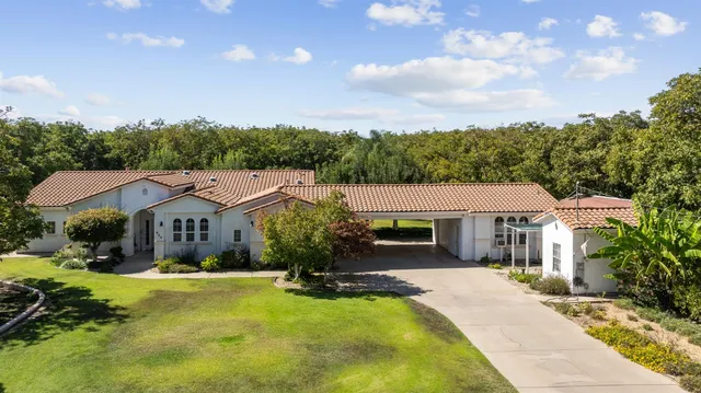 a front view of house with yard and green space