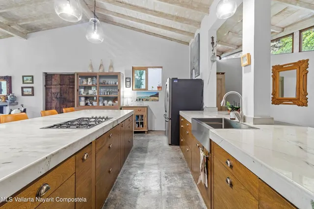 a large kitchen with stainless steel appliances granite countertop a sink stove and refrigerator