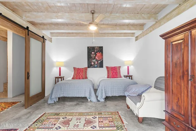 a bedroom with furniture and a rug