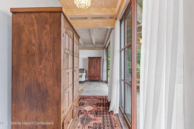 a view of a hallway with wooden floor and stairs