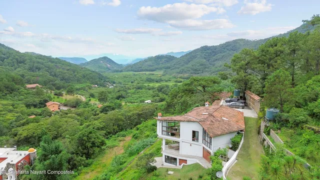 an aerial view of a house with mountain view