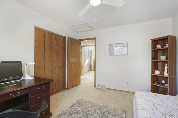 a bedroom with bed and a potted plant