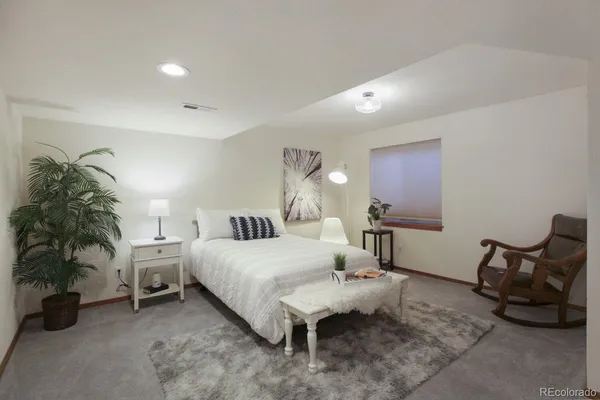 a bedroom with a bed a desk and chair