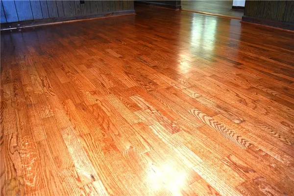 a view of a room with wooden floor and brick walls