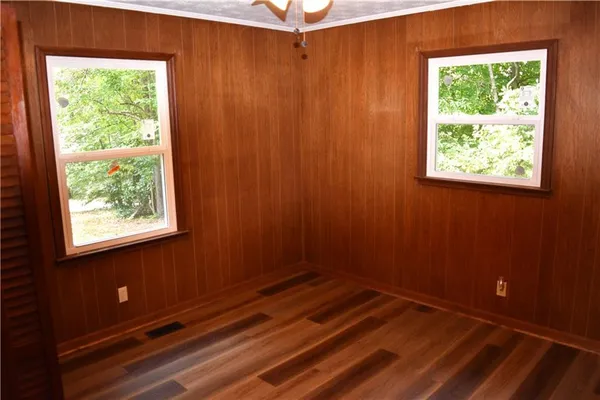 a view of a closet area with wooden floor