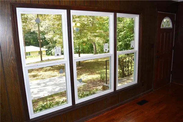 a living room with a air conditioner vent and a window