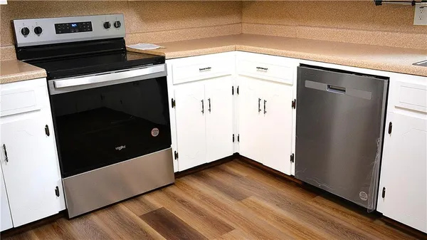 a view of washer and dryer with wooden floor