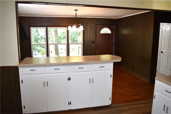 a view with granite countertop sink and a large mirror