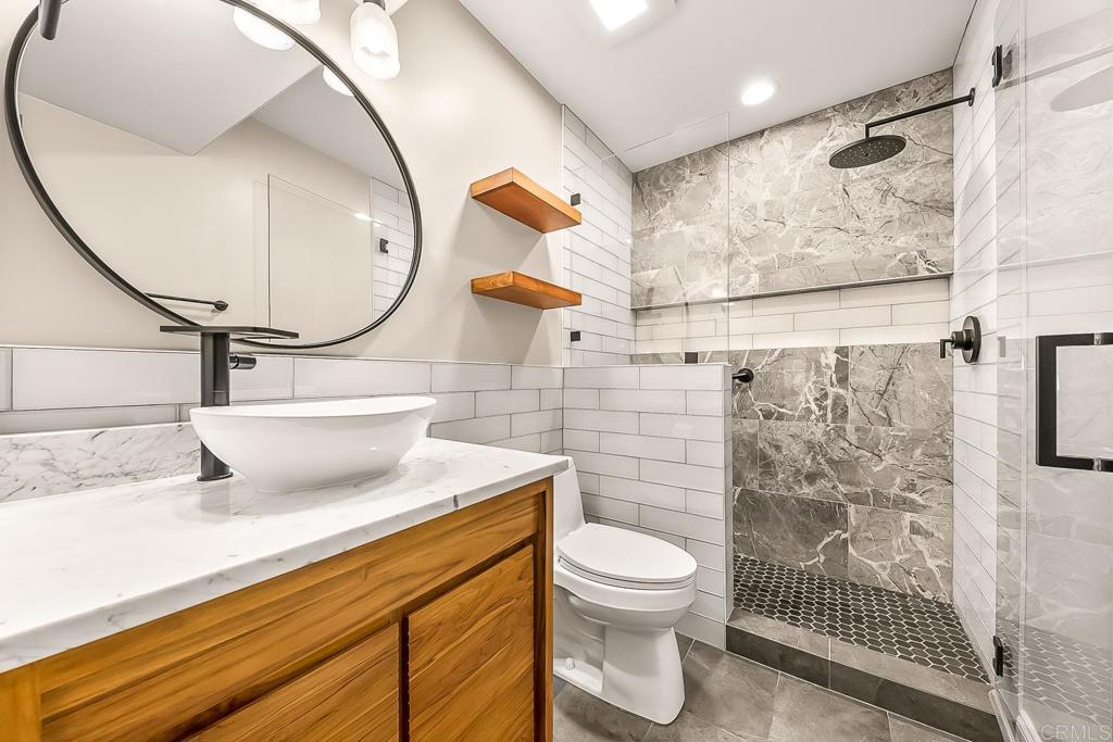 1641 Tucker Lane Encinitas, CA 92024 - Photo 25 of 58 a bathroom with a sink and a mirror