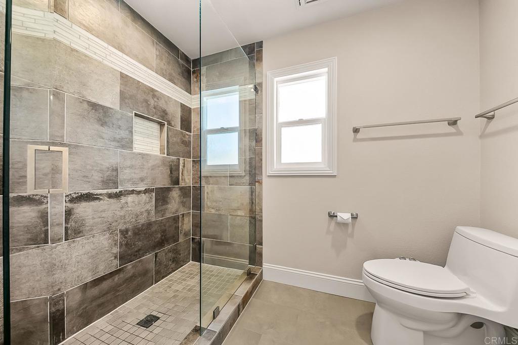 1641 Tucker Lane Encinitas, CA 92024 - Photo 42 of 58 a bathroom with a shower and toilet