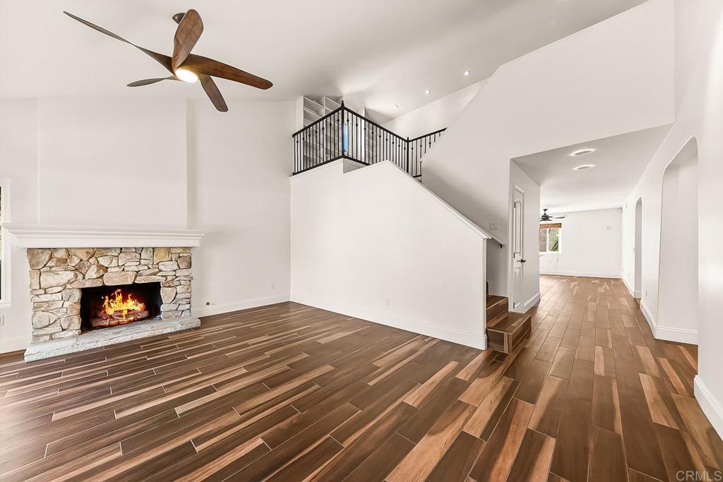 1641 Tucker Lane Encinitas, CA 92024 - Photo 7 of 58 a view of a livingroom with wooden floor and a fireplace