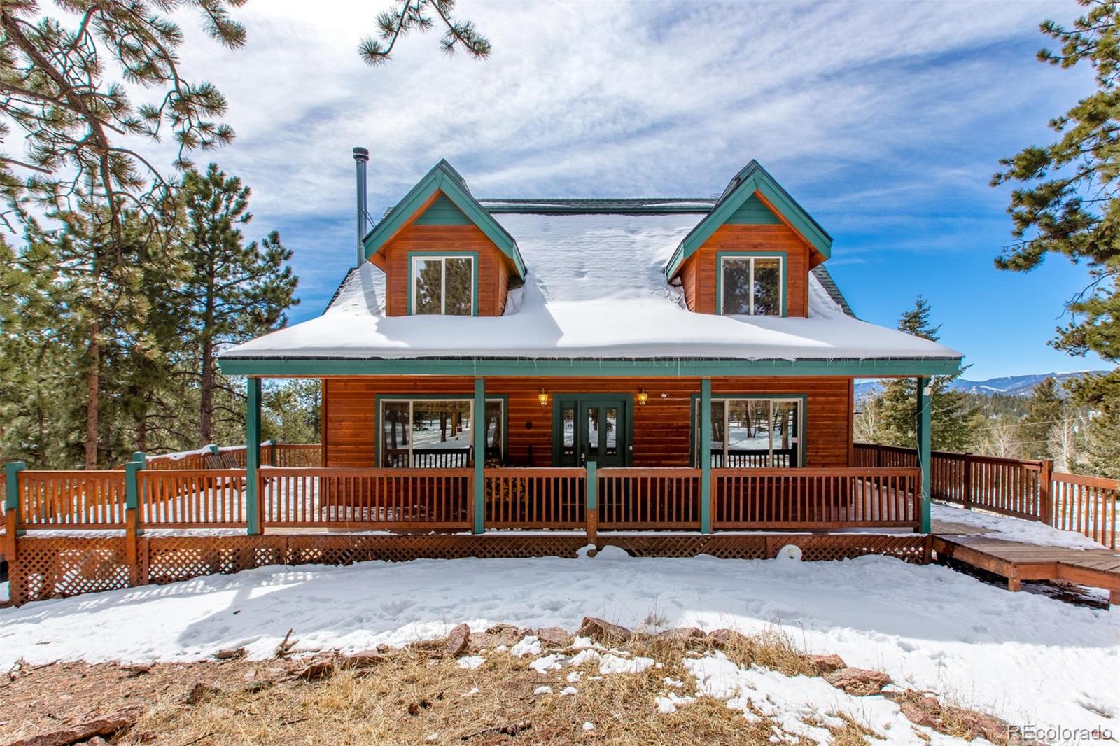 711 Desperado Road Bailey, CO 80421 - Photo 2 of 35 a view of a house with a yard and roof