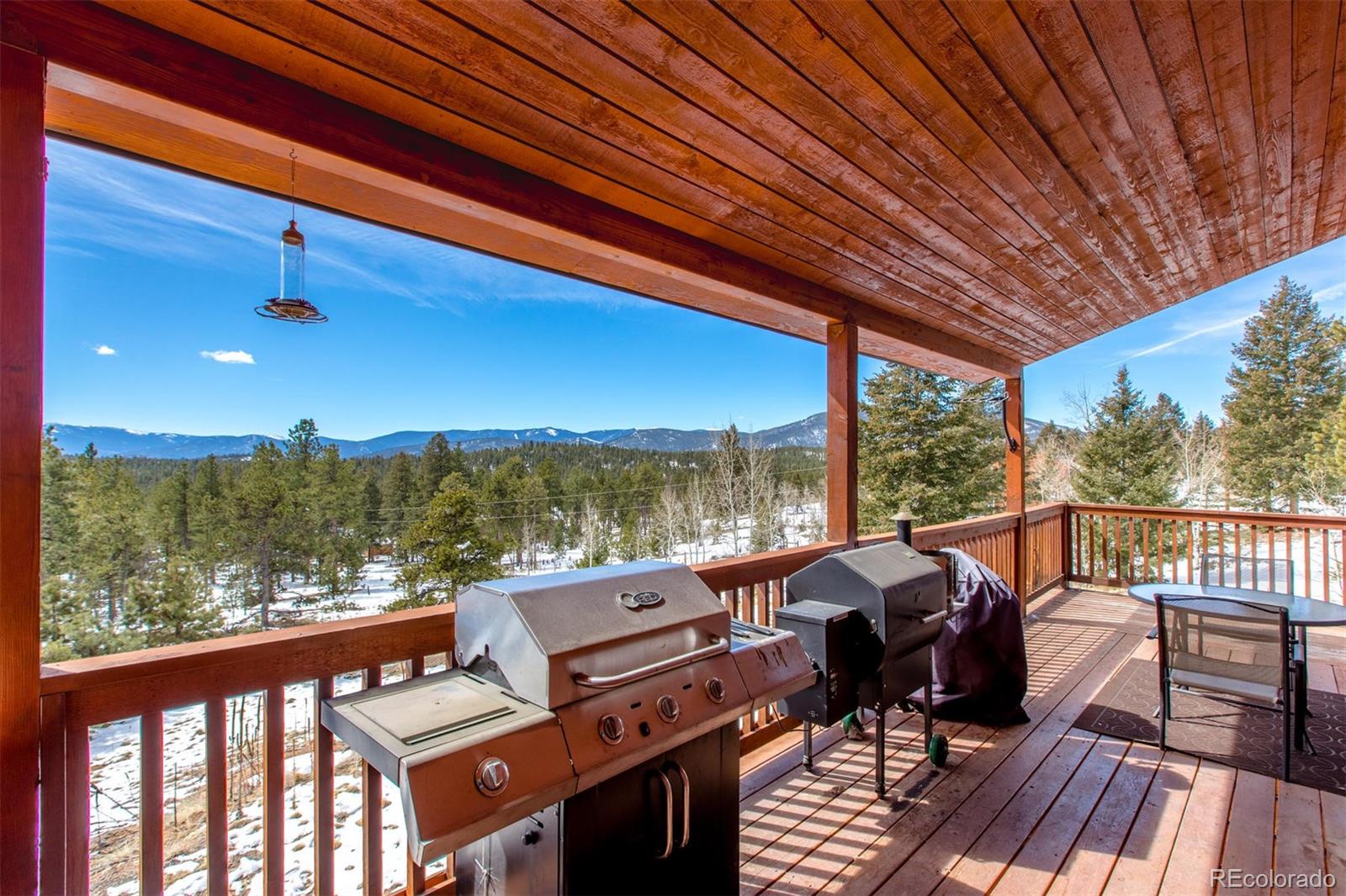 711 Desperado Road Bailey, CO 80421 - Photo 33 of 35 a view of a balcony with furniture and a yard