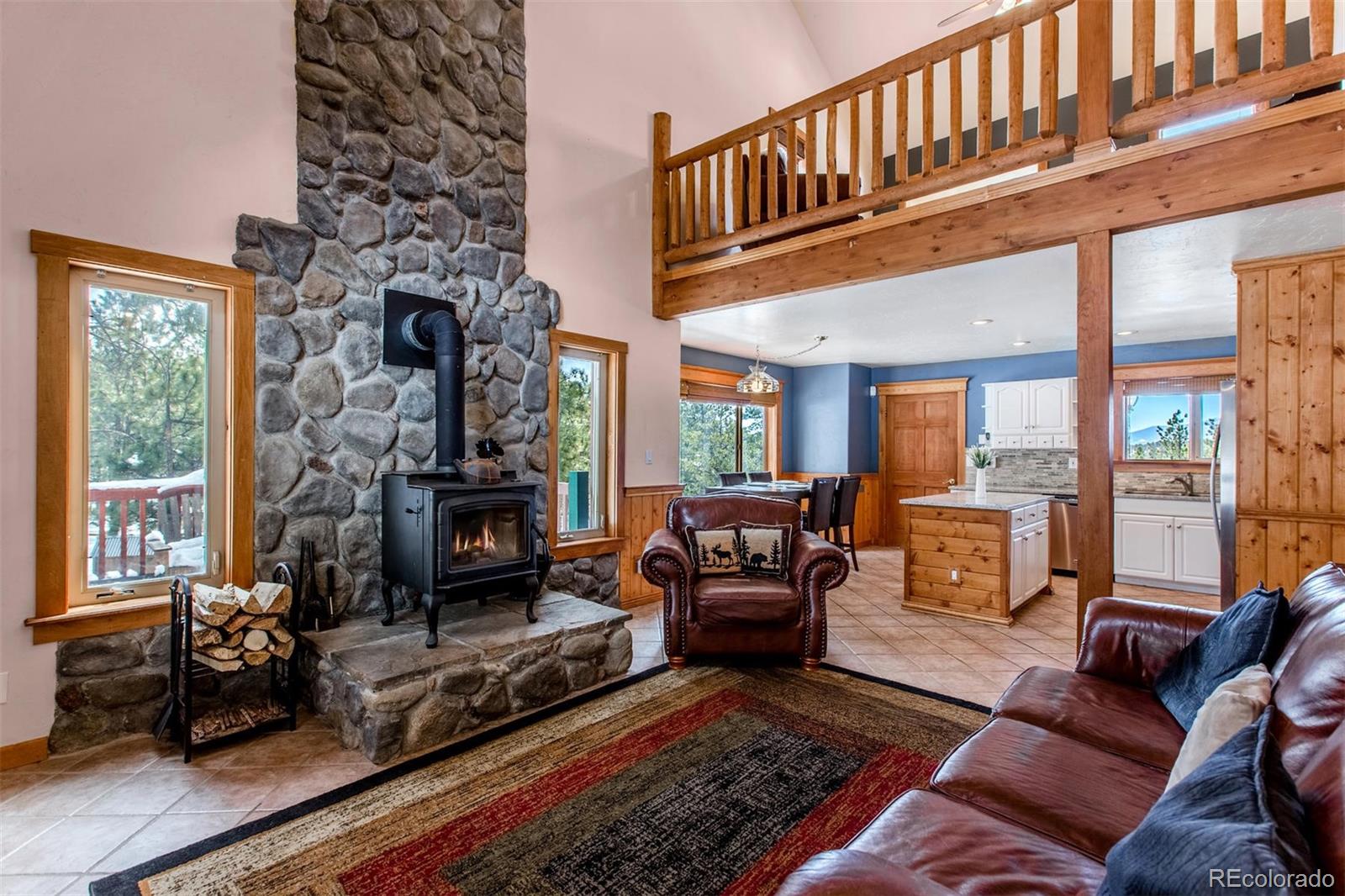711 Desperado Road Bailey, CO 80421 - Photo 5 of 35 a living room with furniture fireplace and a large window