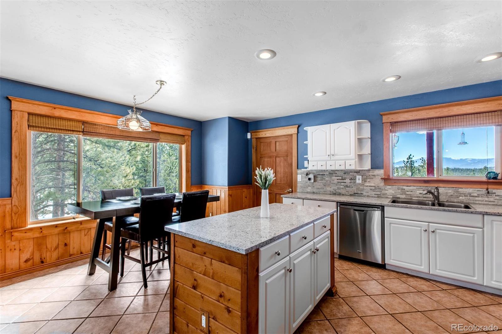 711 Desperado Road Bailey, CO 80421 - Photo 8 of 35 a kitchen with a stove sink and cabinets