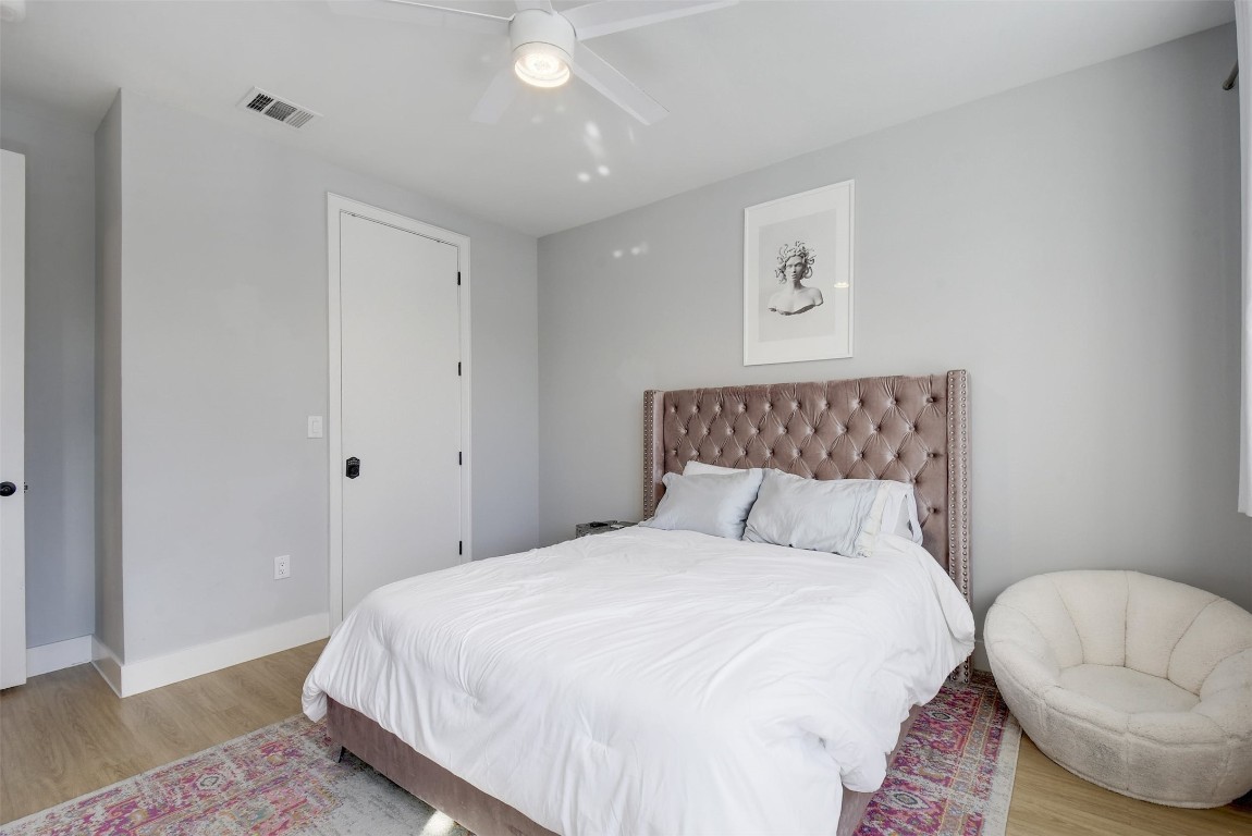 2709 East 5th Street, Unit 2303 Austin, TX 78702 - Photo 11 of 18 a bedroom with bed and a night stand