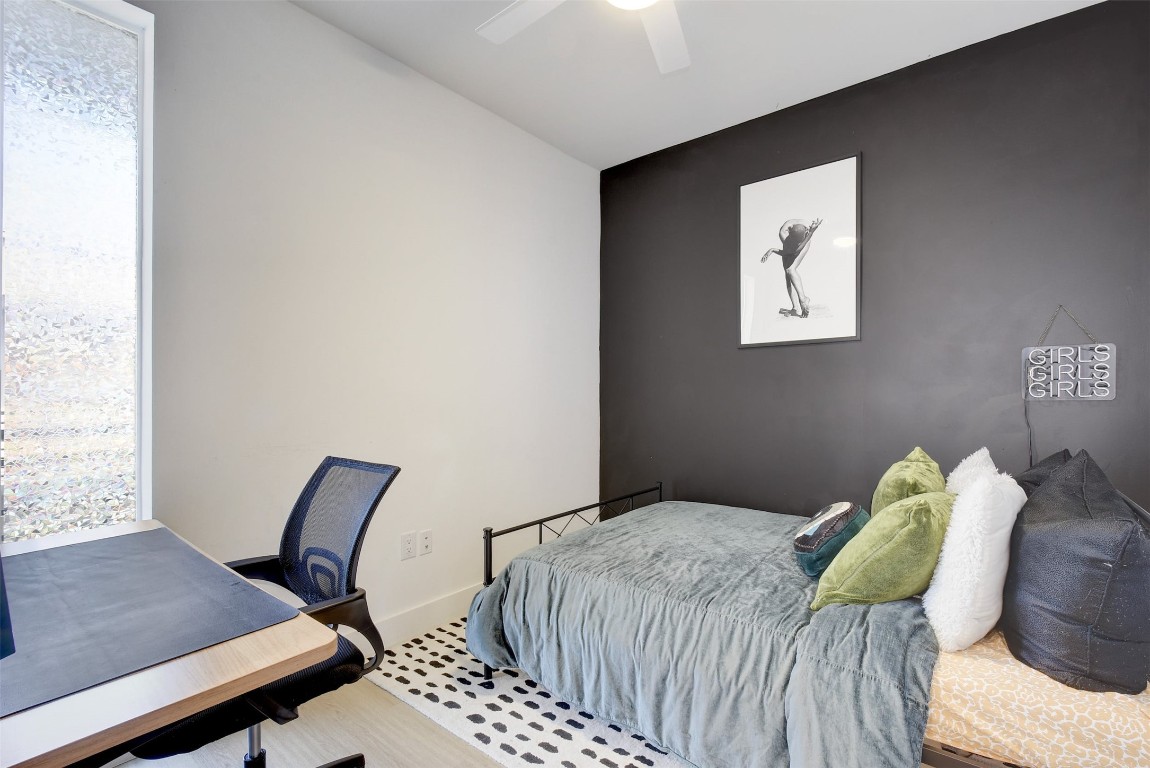 2709 East 5th Street, Unit 2303 Austin, TX 78702 - Photo 12 of 18 a bedroom with a bed and chair