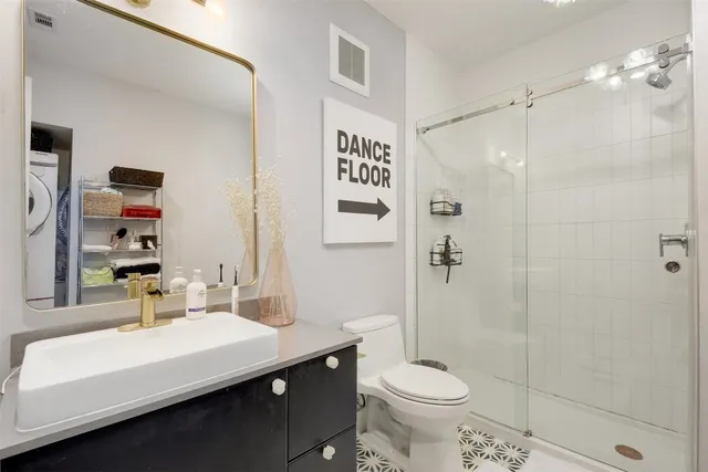 a bathroom with a sink toilet and shower