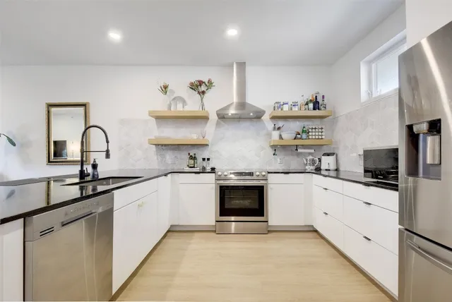 a large kitchen with cabinets a sink and appliances