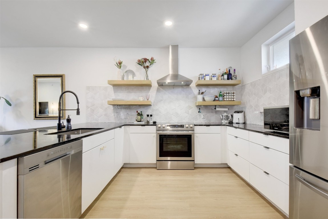 2709 East 5th Street, Unit 2303 Austin, TX 78702 - Photo 3 of 18 a large kitchen with cabinets a sink and appliances