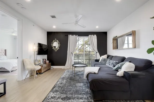 a living room with furniture and a large window