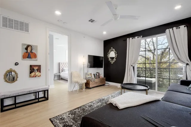 a living room with furniture and large window