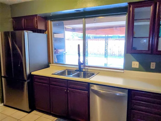 a kitchen with a sink and a refrigerator