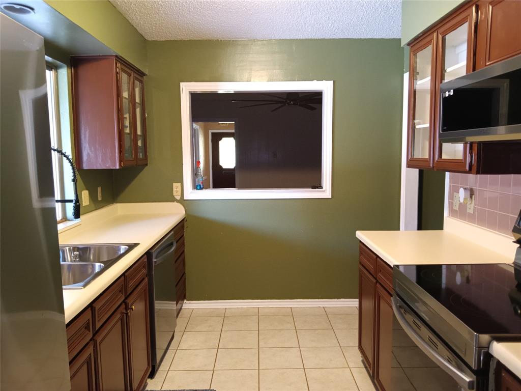 1113 Janell Drive Irving, TX 75062 - Photo 12 of 25 a bathroom with a sink a toilet and a mirror