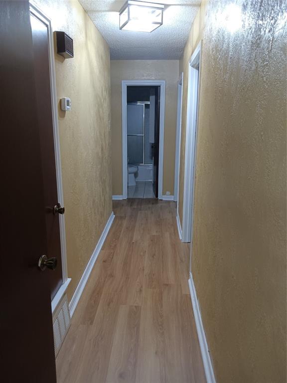 1113 Janell Drive Irving, TX 75062 - Photo 13 of 25 a view of a hallway with wooden floor