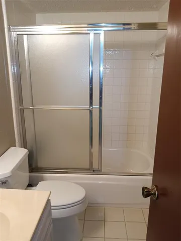a bathroom with a shower and a toilet