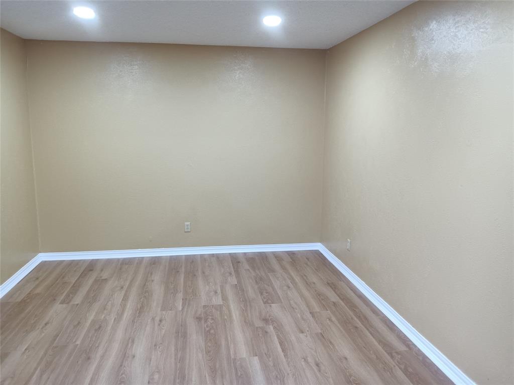 1113 Janell Drive Irving, TX 75062 - Photo 5 of 25 a view of an empty room with wooden floor