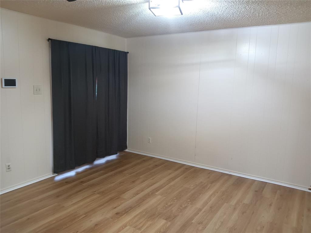 1113 Janell Drive Irving, TX 75062 - Photo 7 of 25 a view of an empty room with wooden floor