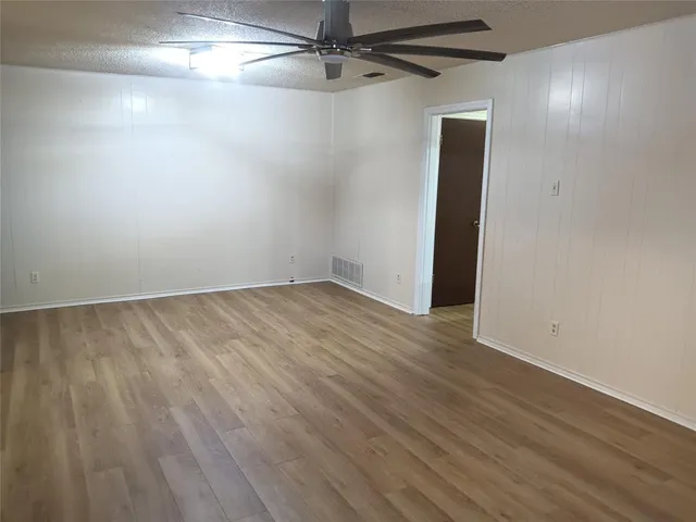 a view of a room with wooden floor