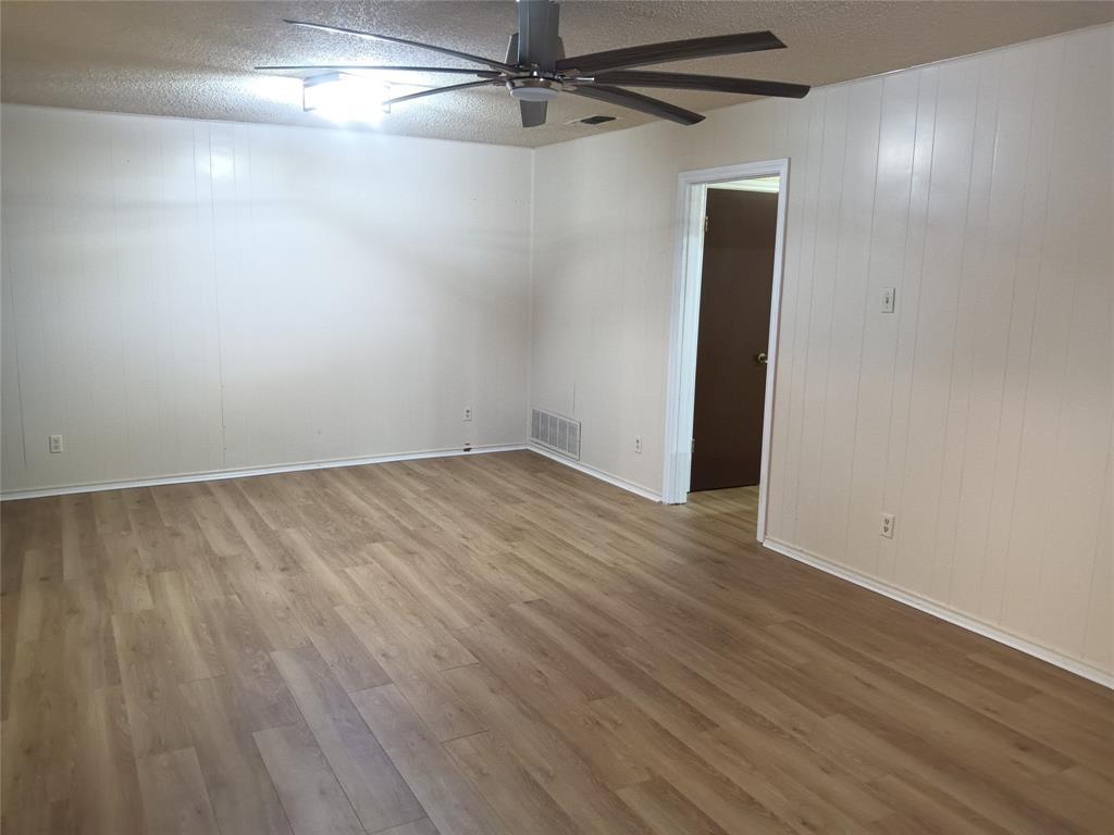1113 Janell Drive Irving, TX 75062 - Photo 8 of 25 a view of a room with wooden floor