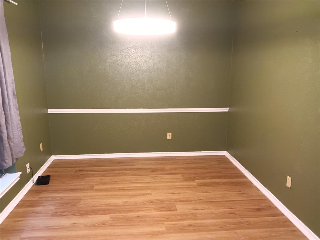 1113 Janell Drive Irving, TX 75062 - Photo 9 of 25 a view of a room with wooden floor