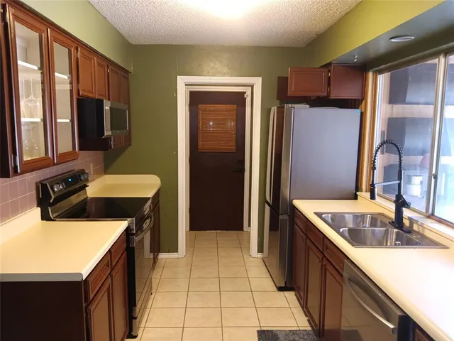 a kitchen with a sink a counter top space and cabinets