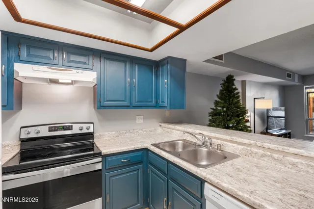 a kitchen with sink and cabinets