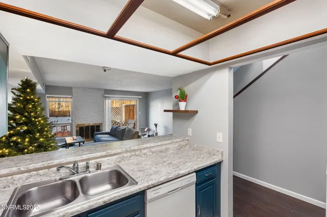 a kitchen with granite countertop a sink and a wooden cabinets