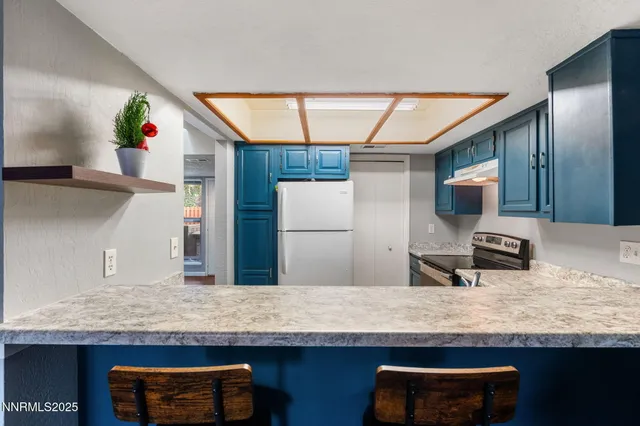 a kitchen with kitchen island granite countertop wooden cabinets and a sink