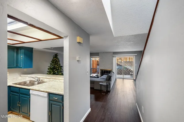 a view of living room and kitchen with furniture and wooden floor