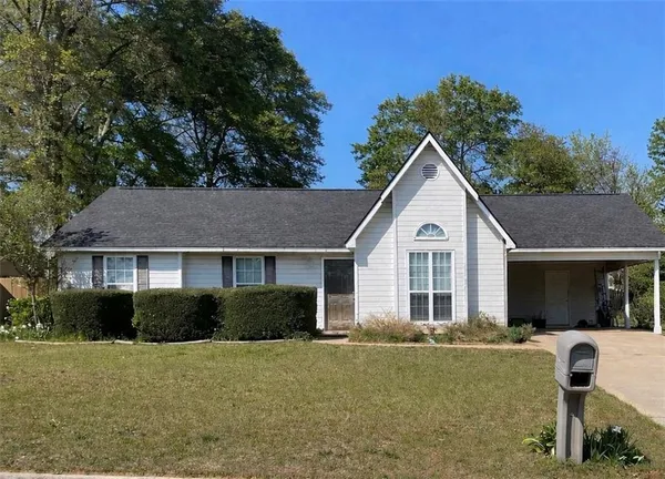 a front view of house with yard and green space