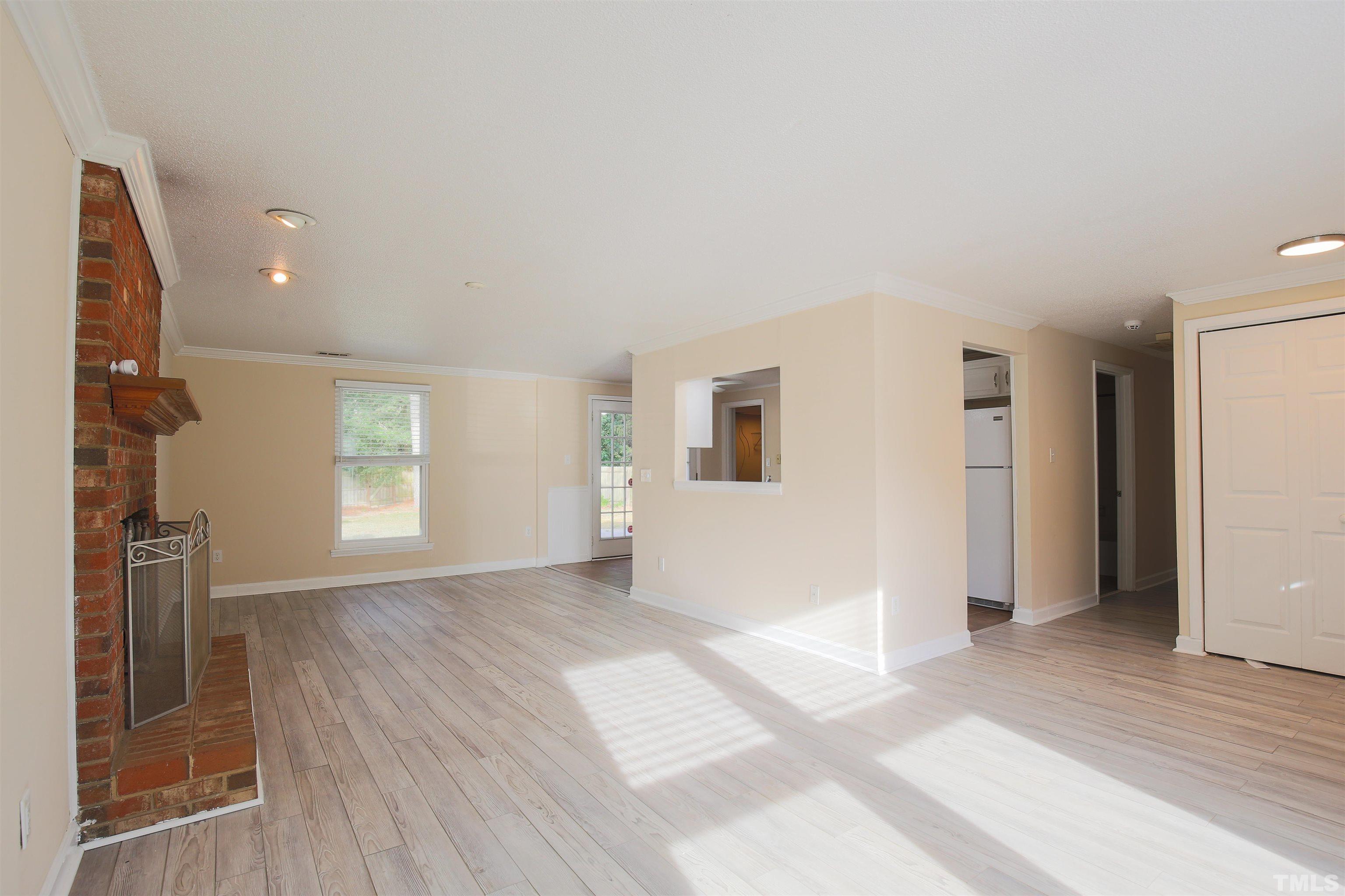 5405 Barbee Road Durham, NC 27713 - Photo 6 of 17 a view of empty room with wooden floor and fan