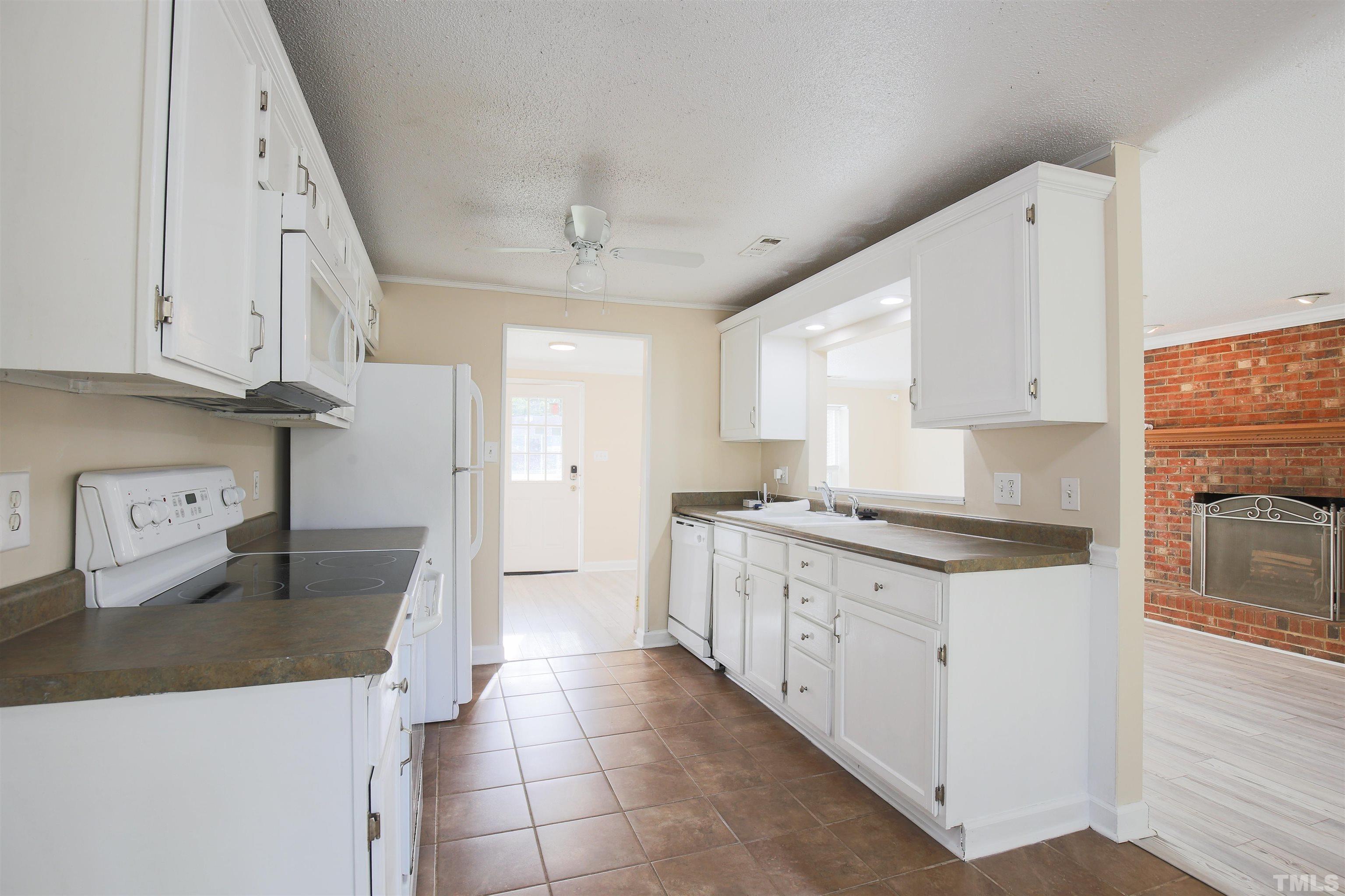 5405 Barbee Road Durham, NC 27713 - Photo 8 of 17 a kitchen with stainless steel appliances granite countertop a sink stove and refrigerator