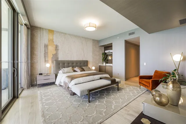 a bedroom with a large bed and a large window