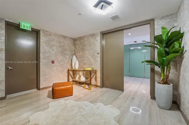 a living room with furniture flat screen tv and floor to ceiling window