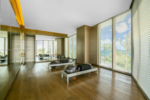 a living room with furniture and floor to ceiling window