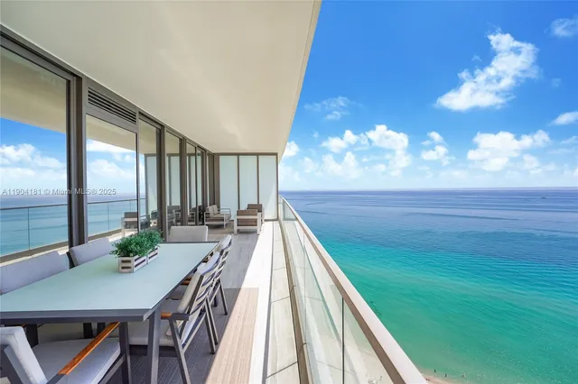 a view of a dining room with furniture a chandelier and wooden floor