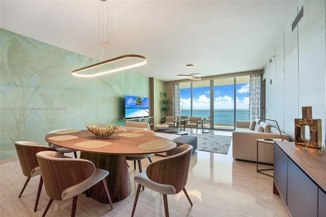 a view of a dining room with furniture large windows and wooden floor