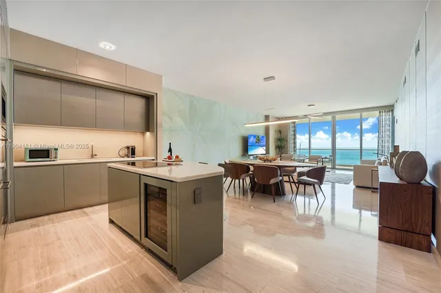 a kitchen with a sink and chairs
