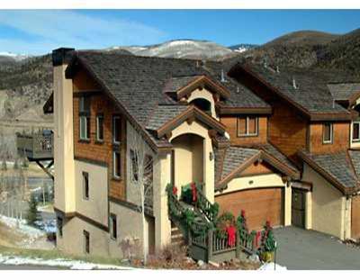 113 Knudson Ranch Road, Unit 113 Edwards, CO 81632 - Photo 1 of 4 a front view of a house with a yard